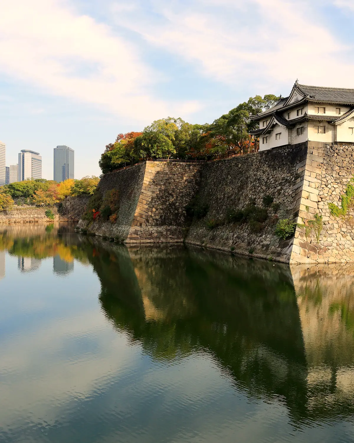Inui-yagura Turret, guarding the outer moat of Osaka Castle and the skyline of Osaka Business Park, Osaka, Japan.