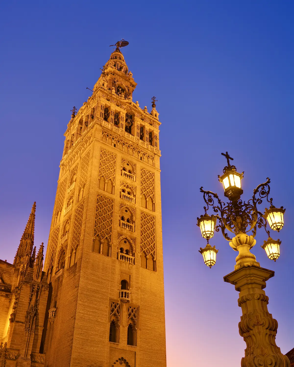 La Giralda at dusk, the tower of the Cathedral of Seville, as viewed from the Plaza Virgen de los Reyes in Seville, Spain. Taken with a Canon 5D and 17-40mm f/4L lens at 30mm.