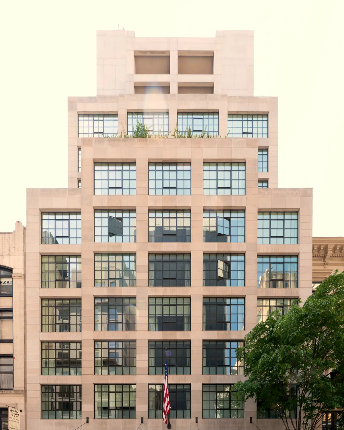 The stone facade of The Whitby Hotel on West 56th Street, with grid windows and a canopy over the entrance