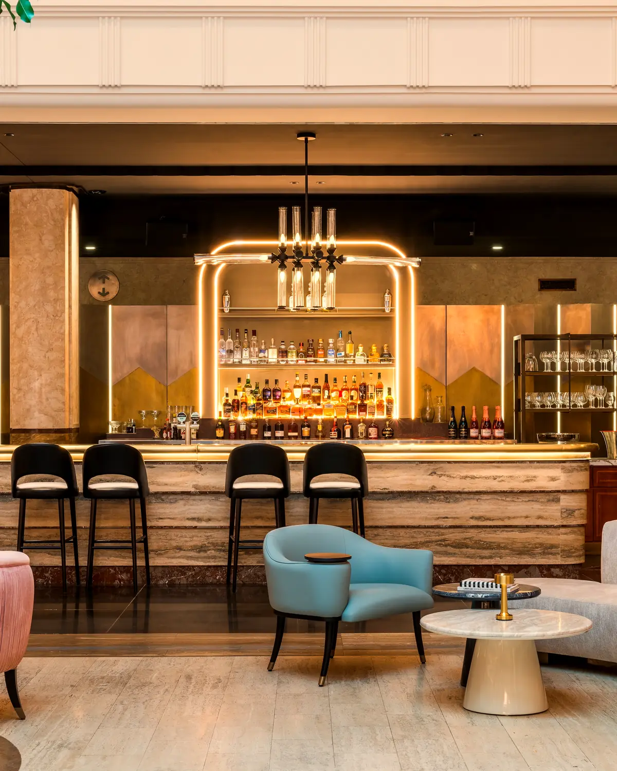 The lobby bar: a marble counter under neon arches, with lounge seating in the foreground (file name kimpton-margot-sydney-2)