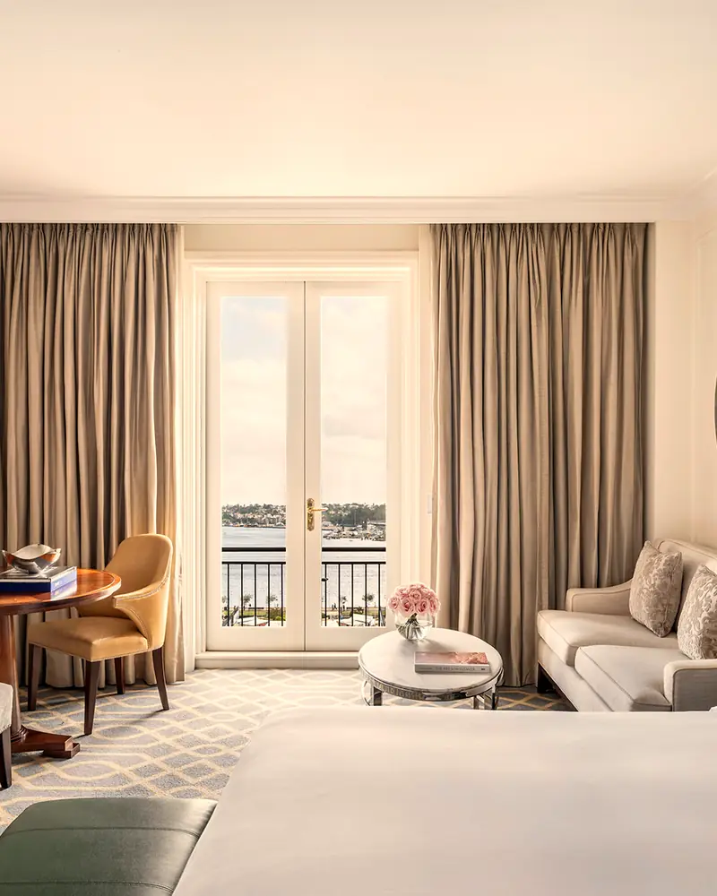 Deluxe Harbour Room, with French doors to a balcony and harbour view (gallery file "tlsyd_deluxe_harbour_room_2025")